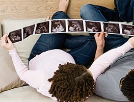 Pregnant woman looking at her week 17 ultrasound photos