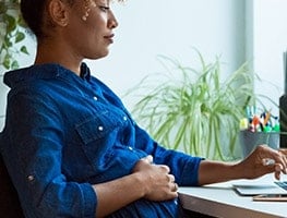 Pregnant week 29 woman sitting at a desk