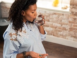 Week 36 pregnant woman enjoying a beverage