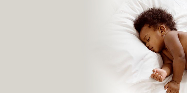 Newborn baby sleeping on white bedding