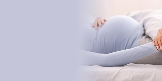 Doctor holding a pregnant woman's hand