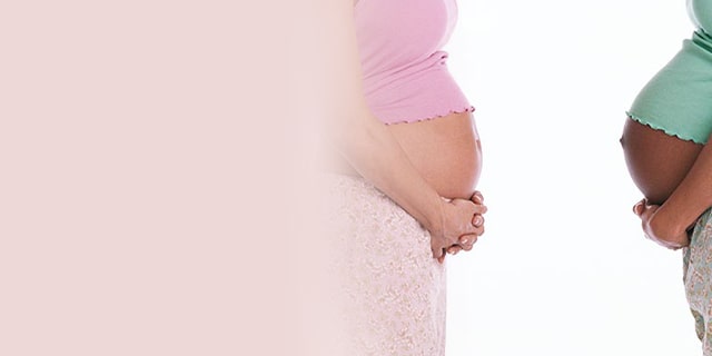 Two pregnant women holding their bellies