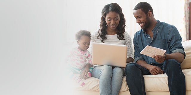Couple and a child on a couch looking at cost of raising a child