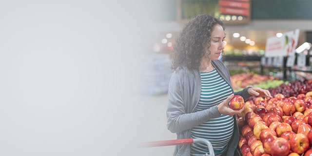 Pregnant woman buying fruit