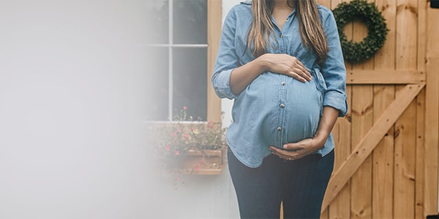Woman holding her pregnant belly