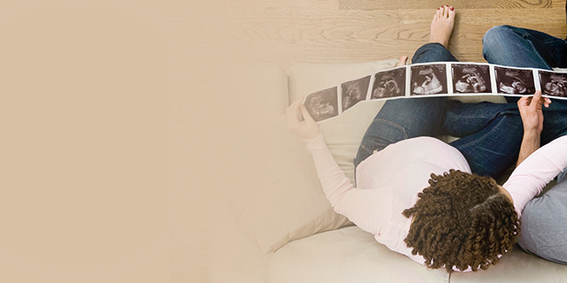 Pregnant woman looking at her week 17 ultrasound photos