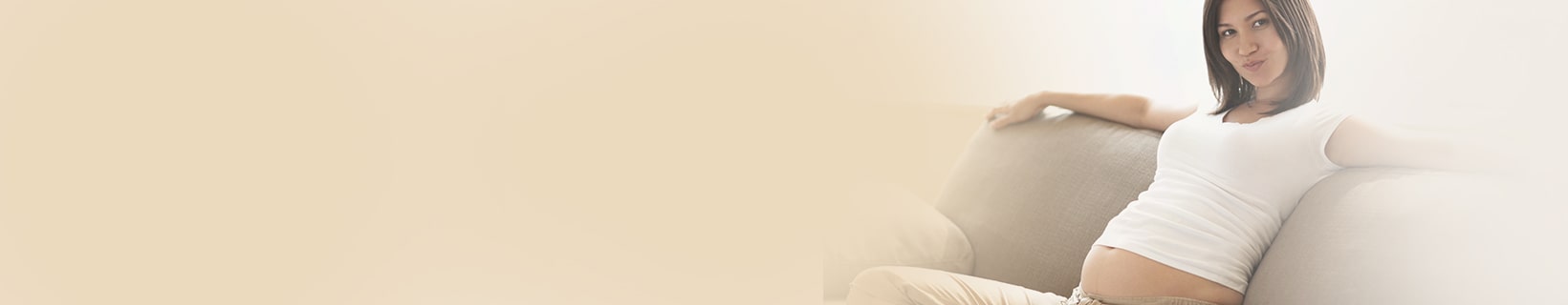 Week 28 pregnant woman sitting on a couch