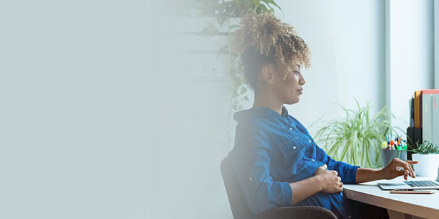 Pregnant week 29 woman sitting at a desk