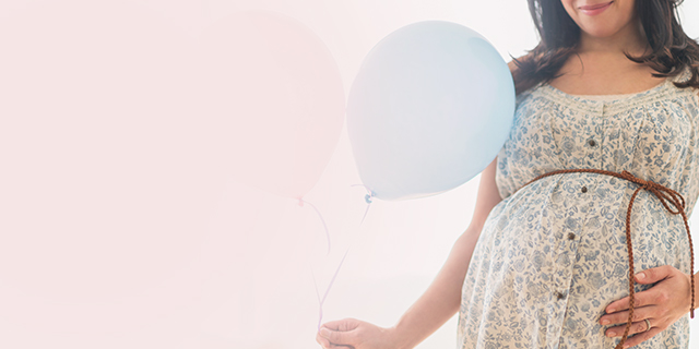 Week 31 pregnant woman holding balloons