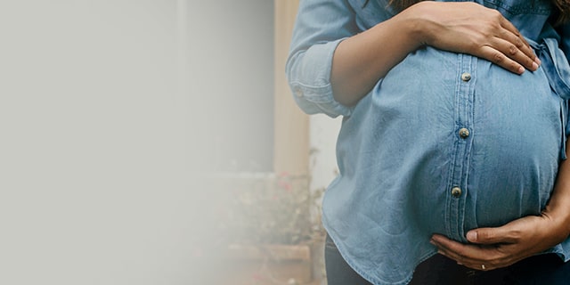 Week 39 pregnant woman holding her belly